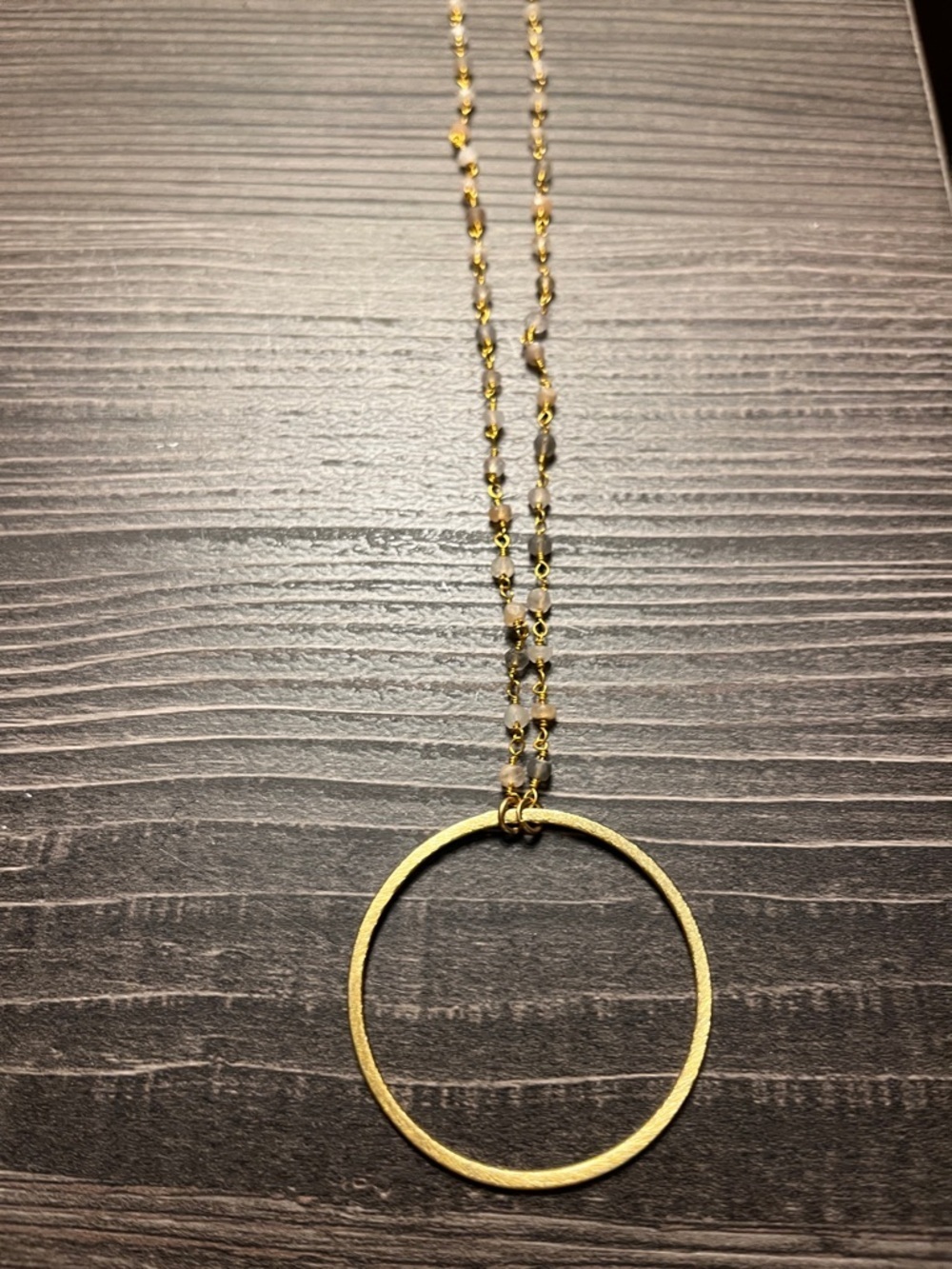 Unbranded gold tone circle pendant necklace.